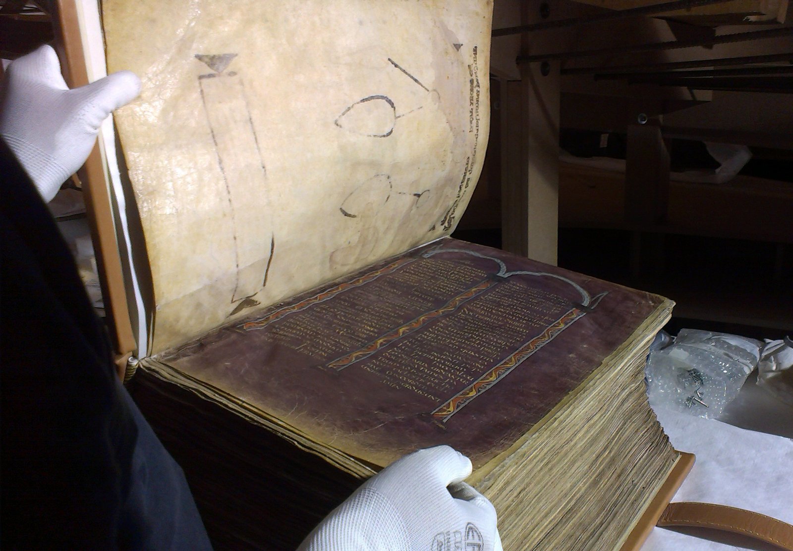 Folio from Codex Amiatinus showing the famous Ezra portrait — a scribe writing at his desk surrounded by tools and the open arc of the Law.