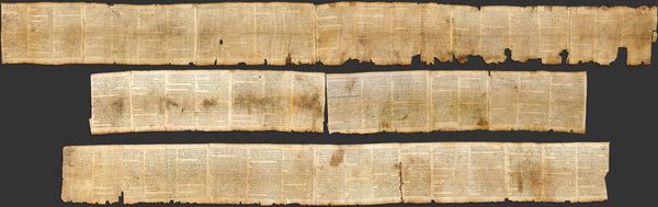 The Great Isaiah Scroll fully unrolled, showing 54 columns of Hebrew text on parchment.